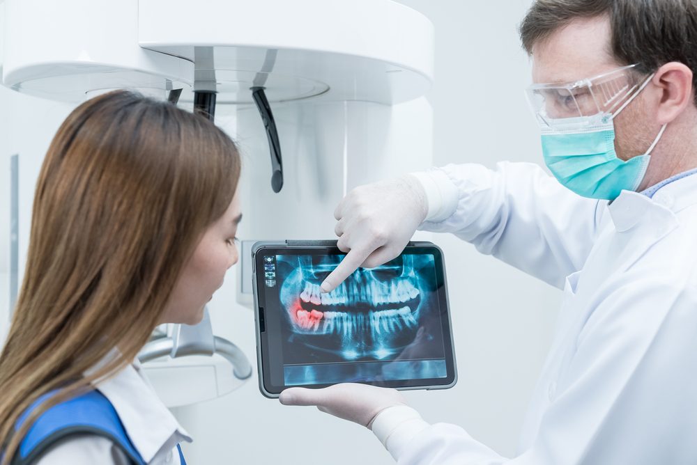 doctor showing his patient her digital dental x rays